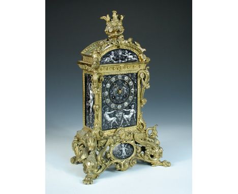 A 19th century ormolu and painted porcelain mantel clock, the decorated cast shaped case with fruiting urn crest above arched