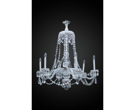 An Austrian cut glass six branch chandelier, with swags of lustres from an inverted crown top to a moulded column and S-scrol