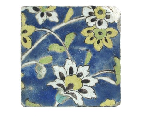 A 17th century Islamic Persian Safavid Cuerda Seca tile, the yellow and white flowers with aubergine stamens and green leaves