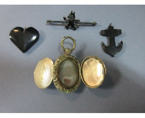 A small eccentric collection of jewellery including an early photograph locket and an early Felix the Cat brooch, the double 