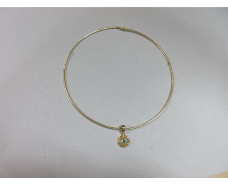 A collar necklace with blue stone pendant, the partially articulated circular reeded wire collar suspending a circular pendan