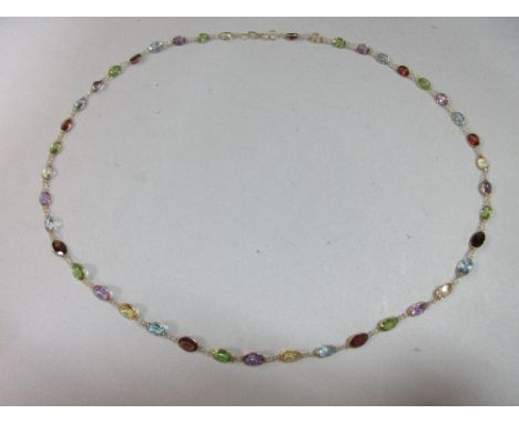 A multi-coloured gemstone necklace, designed as a slightly graduated line of oval cut rainbow coloured stones, to include per