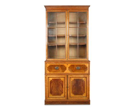 A George III Sheraton style satinwood secretaire bookcase, crossbanded in purpleheart, the cornice with dentil inlays, astrag