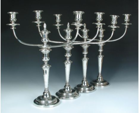 A set of four Regency silver three light candelabra, by Smith, Tate, Nicholson & Hoult, Sheffield 1813/1817 each raised from 