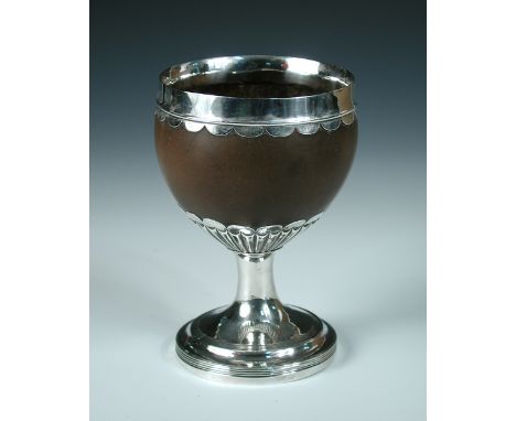 A George III silver mounted coconut cup, by Josiah Snatt, London1813, the smooth bowl mounted on a fan fluted pedestal with r
