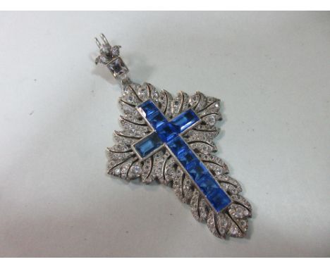 A blue and white paste crucifix, the Latin cross formed by channel set square and rectangular cut light blue stones, to an or