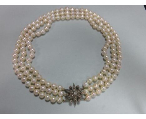 A three row pearl necklace with antique diamond clasp, the slightly graduated 7.5 - 10.2mm cultured pearls, individually knot
