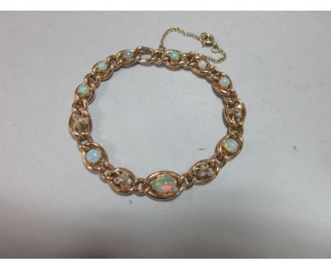 An opal and diamond bracelet, the graduated curb link chain with alternating larger stone set and smaller plain links, with a