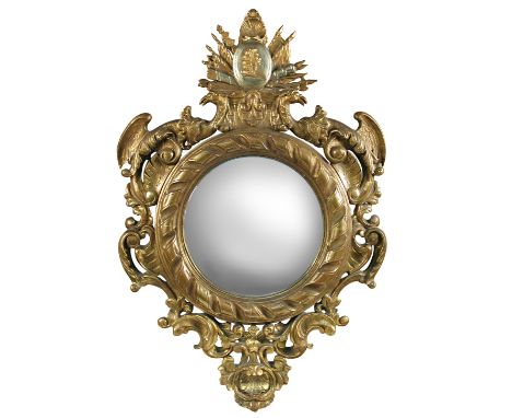 A 19th century continental gilt gesso framed convex mirror, decorated with military campaign trophy, eagle wings and scrolls,