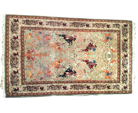 A Tabriz jade green ground rug, decorated with hunting parties, within a border of Arabic script 250 x 140cm (98 x 55in) Bind