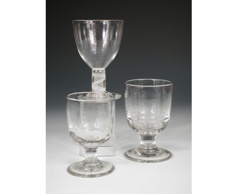 An opaque stemmed rummer together with two others, the ovoid bowl of the first above the stem and circular foot, 14cm (5.5 in