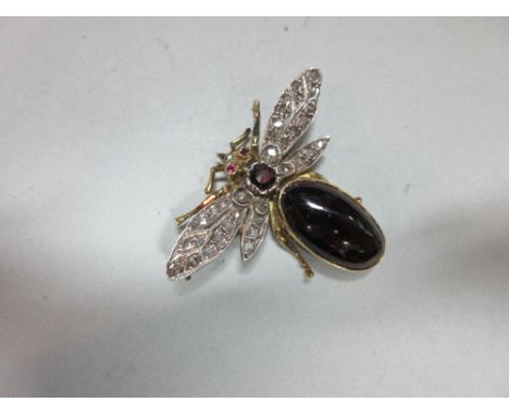 A 19th century diamond and garnet bee brooch, the millegrain veined wings set throughout with rose cut diamonds, the abdomen 