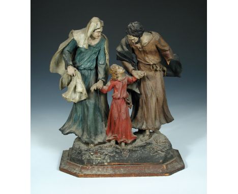 A carved wood group of the Holy family, two praying nuns and a key board player, Mary and Joseph each holding a hand of their