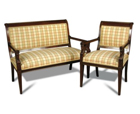 A late 19th century Empire style mahogany framed three piece suite, upholstered in a yellow tartan fabric, carved with sphinx