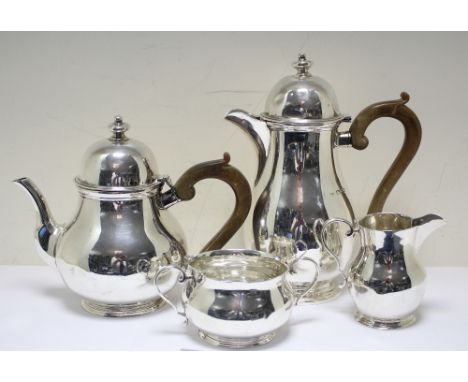 A Queen Anne style silver four piece tea set, by Josiah Williams & Co, London 1940, comprising:- a teapot of baluster form wi