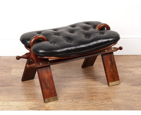 Camel saddle stool 20th Century, with black button upholstered seat cushion, the base with brass inlaid in repeating foliate 