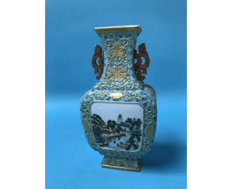 A small Chinese vase, decorated with landscape panels, pierced handles and seal mark to base, 20cm height