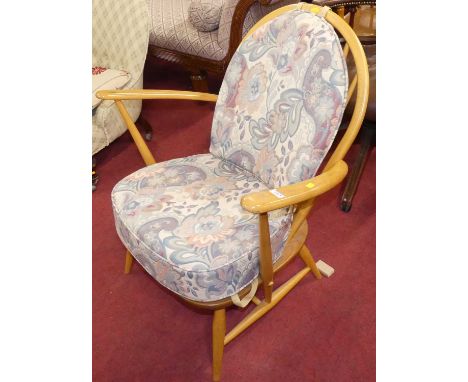An Ercol blond elm stick back elbow chair, width 70cmSolid wooden seat.