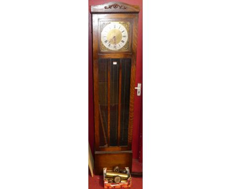 A circa 1920s oak longcase clock, having a three-train striking and chiming movement, with weights and pendulum
