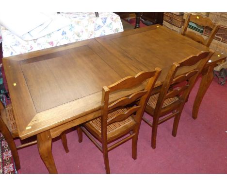 A contemporary French cherry wood dining suite, comprising extending dining table with pull-out action and single drop-in lea