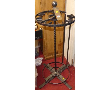 A contemporary anodised steel cylindrical stick stand, with spiral turned column, united by stepped X-frame base, height 106c