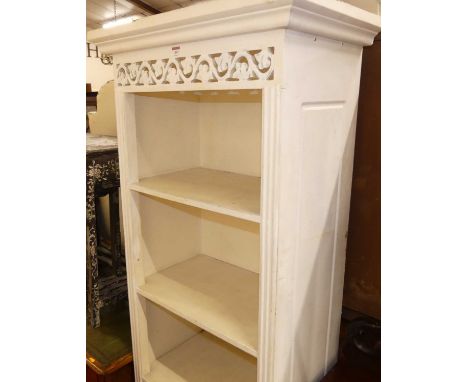 A painted French style narrow open display shelf, having twin long lower drawers, width 66cm