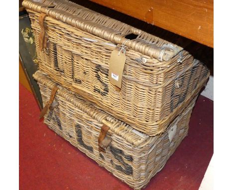 A wicker hamper with leather strap and black painted monogram, w.78cm; together with another similar example (2)