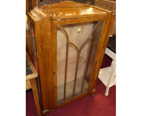 An Art Deco figured walnut ledgeback single door glazed china display cabinet, on squat claw and ball supports, w.76.5cm 