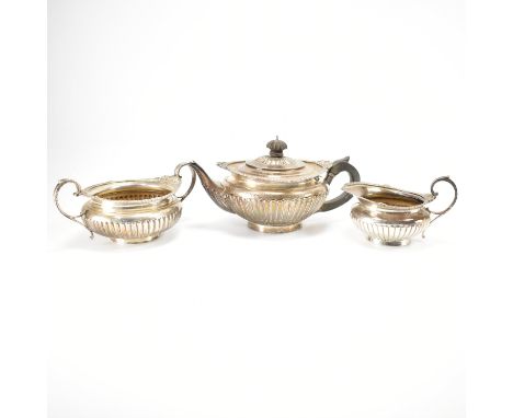 A silver hallmarked tea service. The service having gadrooned sides, with moulded foliate details to the rims and with carved