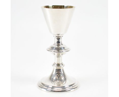 An Edwardian hallmarked silver whisky toddy. The vessel being raised on a flared plinth decorated with an engine turned emble