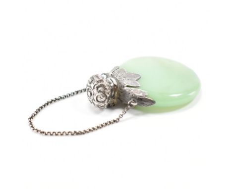 An early 20th Century Edwardian silver and jade chatelaine scent bottle. The bottle of round shape with a silver foliate coll