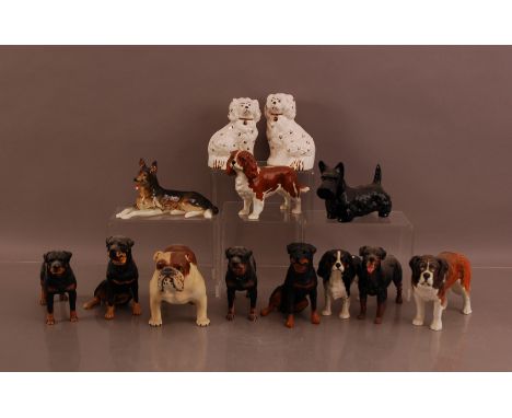 A collection of ceramic dogs,  comprising six Beswick examples, and two early 20th century Staffordshire dogs (13)