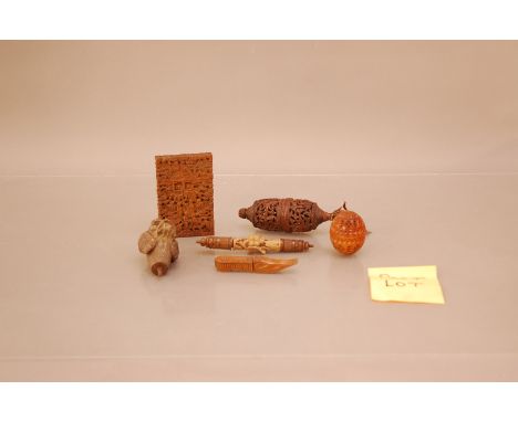 A Collection of carved Far Eastern hardwood treen items, including a card case 11cm high, a carved egg, together with a colle