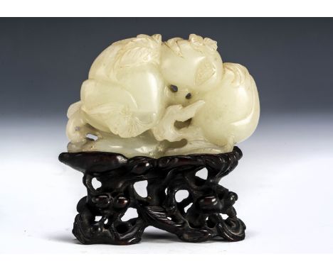 A Chinese Qianlong Jadeite Jade carved panel, of fruit, gourdes and roots, on a pierced hardwood base, 6.5cm x 7cm 