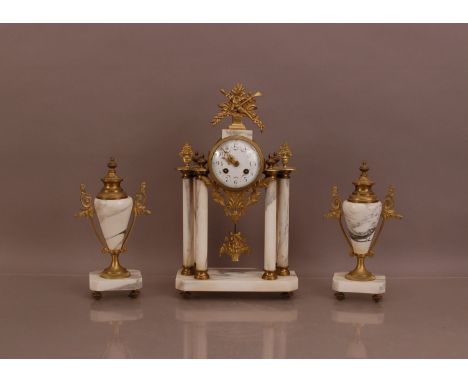 An early 20th century brass and marble Garniture, the eight day clock with finial lose, 41cm high, enamel dial with Arabic nu