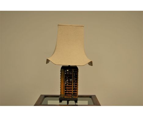 A c1970s Japanese lamp base, constructed with four abacus, with cream shade, total height 68cm
