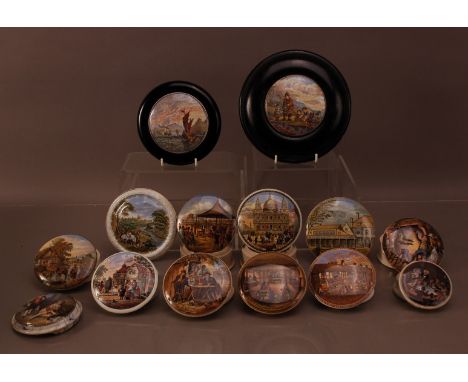 A large collection of 19th century ceramic pot lids and pots, with a variety of scenes and sizes, two mounted in ebonised fra