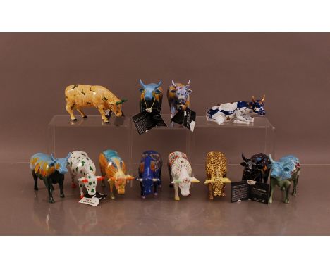 A collection of ceramic Cow Parade cows, comprising an assortment of cows, some American related examples (12)
