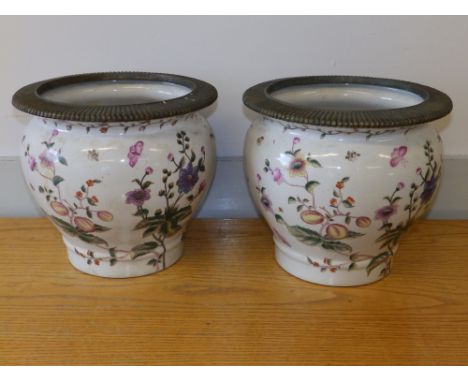 A pair of Chinese porcelain jardinieres of swelling form, painted with flowering plants and insects, having fluted bronzed ri