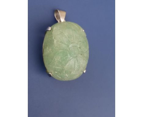 A floral carved cabochon jade coloured/quarzite pendant , four-claw set in white metal,  1.6" overall.