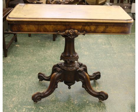 A Victorian burr walnut card table, rounded rectangular top with foliate scroll decorated apron, on four 'c' scroll legs, cer