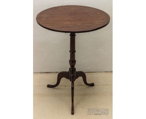 A George III mahogany tilt top tripod table c1780, the ring turned column with scrolled legs and small pad feet, 52 x 69cm