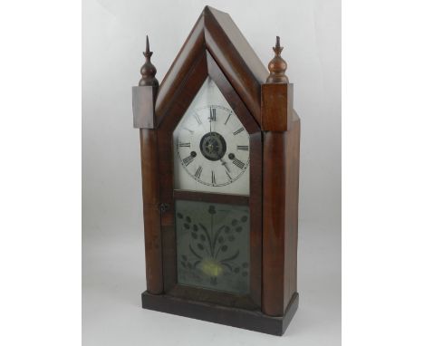 An early 20th century American mahogany steeple shaped shelf clock, having turned conical finials above the painted metal dia