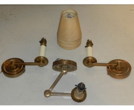 Two single branch wall lights, together with one articulated brass wall light. (3)