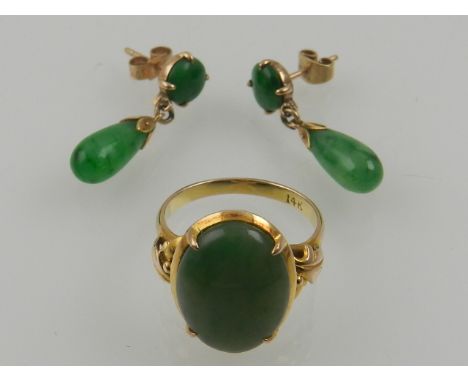 A yellow metal and jade ring, set oval cut cabouchon jade, the shank stamped 14k, together with a pair of yellow metal and ja