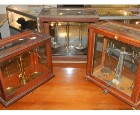 Three wooden and glazed cased scales. (3)