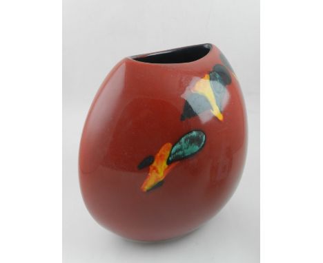 A large Poole Pottery Odyssey Purse vase, with splashes of yellow, black and turquoise on a vivid red ground.  