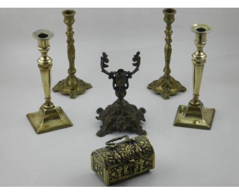 A pair of late 19th century brass candlesticks with square bases, together with a pair foliate cast sticks, a box and another
