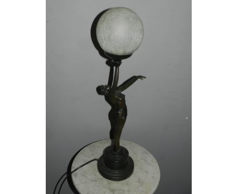 An Art Nouveau style table lamp modelled in the form of an exotic dancer holding an illuminated globe above her head, H. 68cm