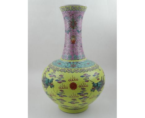 A Chinese polychrome decorated porcelain vase, the neck decorated with scrolls and sprays of flowers above dragons chasing pe